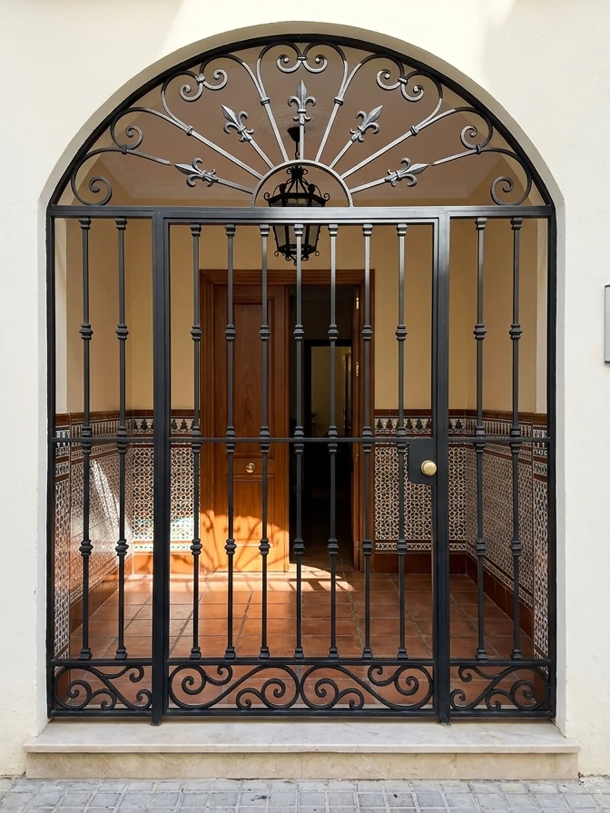 Puerta de protección y reja de diseño en arco para vivienda en Sevilla
