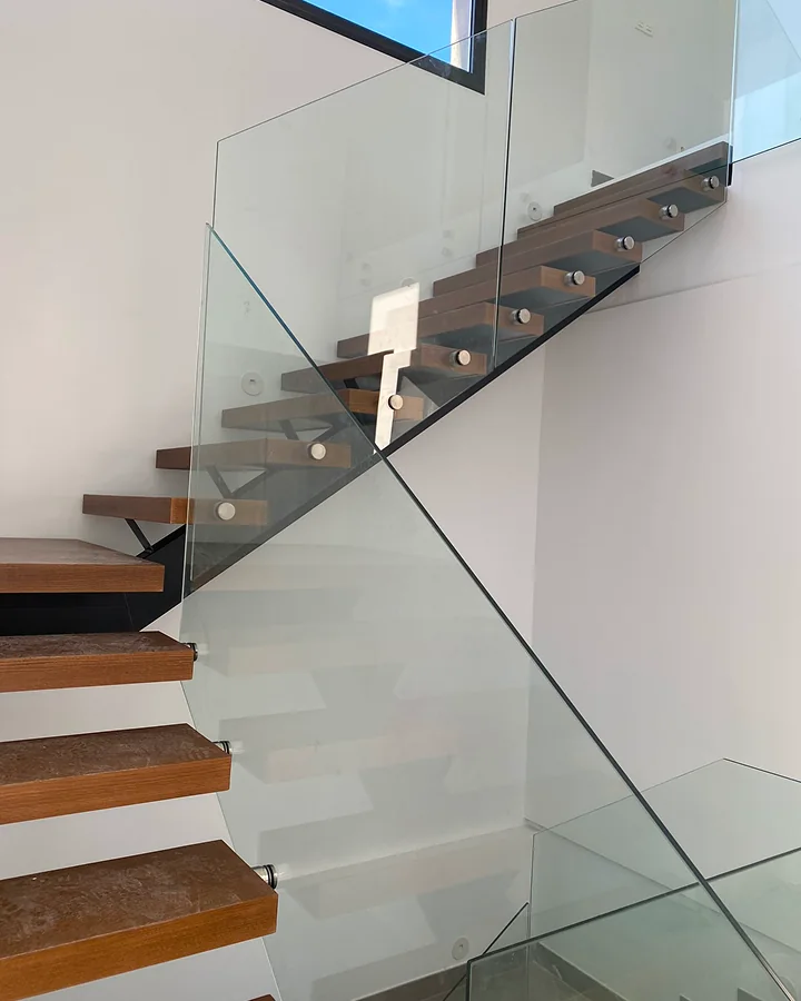 Estructura metálica para escalera de madera con barandilla continua de vidrio · Madera no incluida